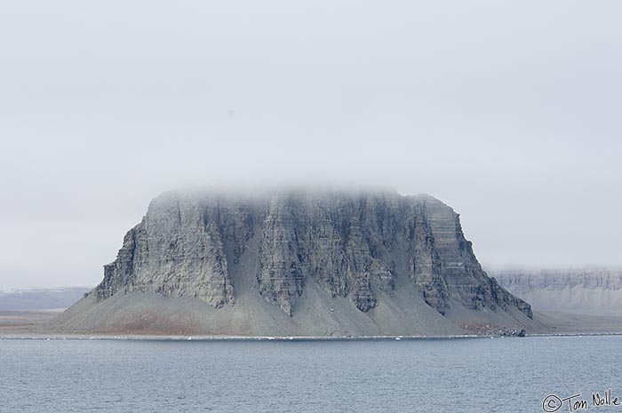 ArcticQ_20080827_143704_601_2X.jpg - Clouds obscure the top of a rocky mountain on the beach of Radstock Bay, Devon Island, Nunavut, Canada.