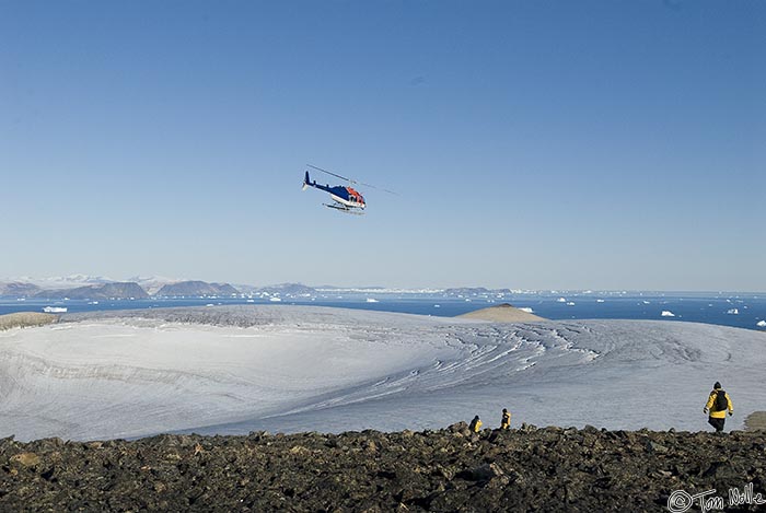 ArcticQ_20080829_145044_834_20.jpg - One of our two helicopters wheels out from the landing spot at the Peary monument to return for another load.  Cape York, Nunavut, Canada.