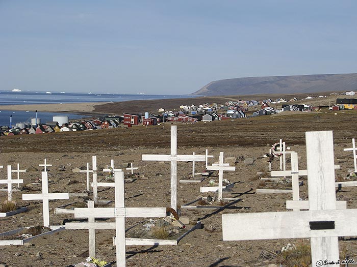 ArcticQ_20080830_091802_536_S.jpg - The lively town beyond the crosses shows that life and death are in careful balance in the north.  Qaanaaq,Greenland.