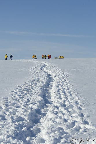 ArcticQ_20080830_154204_013_2X.jpg - Passengers leave a trail through fairly deep snow on a portion of the ice cap near Qaanaaq Greenland.