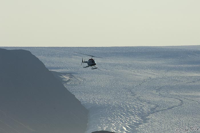 ArcticQ_20080831_080752_140_2X.jpg - The scout 'copter comes back, swooping over a glacier in Etah Greenland.