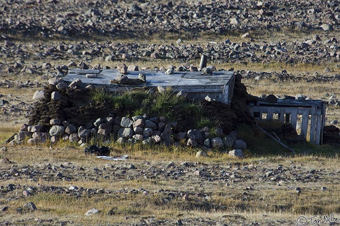 ArcticQ_20080831_095402_155_2X.jpg - Turf, wood, and rocks have been used to cobble together this abandoned hut in Etah Greenland.