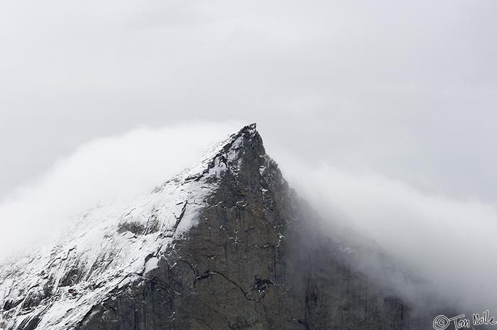 ArcticQ_20080906_091914_894_2X.jpg - A high mountain peak in Sam Ford Fjord gathers a bit of a cloud veil. Baffin Island, Nunavut, Canada.