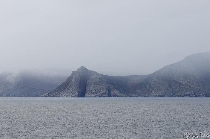 ArcticQ_20080907_164228_223_2X.jpg - By a cosmic geographical accident, the vertical seam in this rocky cliff on Baffin Island, Nunavut, Canada nearly aligns with the position of the Arctic Circle.