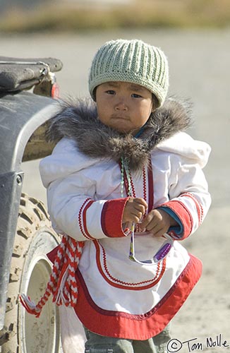 ArcticQ_20080908_121214_250_2X.jpg - A cute little Inuit girl steps away from her mom far enough to get in a picture.  Pangnitung, Baffin Island, Canada.