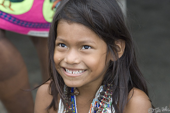 CostaRica_20100319_114236_046_2X.jpg - An Embera girl smiles at tourists.  These people apparently welcome our visits and are fairly natural in their behavior around tourists.  Darien Jungle, Playa de Muerto, Panama.