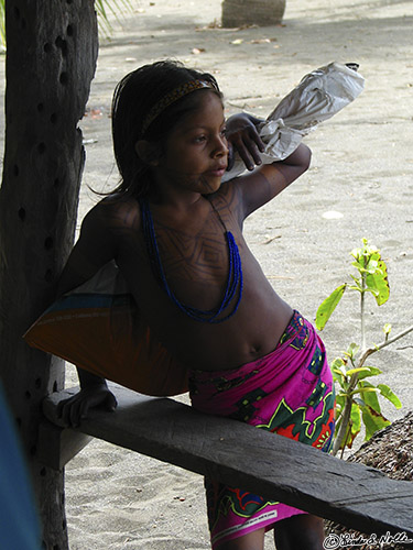 CostaRica_20100319_115638_066_S.jpg - A young Embera girl stands in the shadows and watches the village activity, wondering perhaps about her own future.  Darien, Panama.