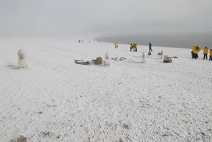ArcticQ_20080827_092700_633_20.jpg - The four graves against the snowy backdrop of the sea bring the incredible sense of loneliness we've seen at other polar-region grave sites.  Beechy Island, Nunavut, Canada.