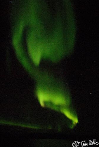 ArcticQ_20080908_225232_965_20.jpg - Swirls of green light with some yellow and orange; these are fairly typical colors for an aurora display.  Baffin Island, Nunavut, Canada.